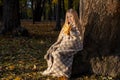 little blonde girl in a plaid whip in the park in autumn Royalty Free Stock Photo