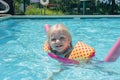 Little blonde girl playing at the pool on a summer day Royalty Free Stock Photo