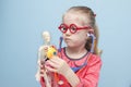 Little blonde girl with red glasses listen heart with stethoscope Royalty Free Stock Photo