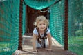 Little blonde girl in the rope park. Royalty Free Stock Photo
