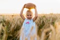 a little blonde girl in a rye field, a happy child with a rye round bread Royalty Free Stock Photo