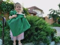 A little blonde girl smiles while holding a gift in her hands. Gift wrapping. Royalty Free Stock Photo