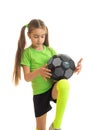 Little blonde girl in sport uniform playing with soccer ball Royalty Free Stock Photo