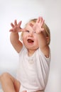 Little blonde girl in white T-shirt during play Royalty Free Stock Photo