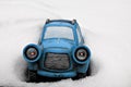 Little Blue toy car stuck in snow