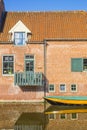 Little boat in front of an old house at the Berkel river in Zutphen Royalty Free Stock Photo
