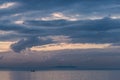 A little boat in the middle of a lake with beautiful, big sunset clouds and reflections Royalty Free Stock Photo