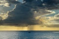 Little boat sailing in a calm sea and with the storm and clouds approaching on the horizon Royalty Free Stock Photo