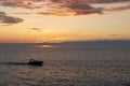 Little boat sails at the warm sunset on the North Sea
