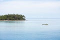 A little boat and a tropical island in Tonga