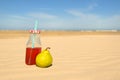 Bottle lemonade and fruit at beach Royalty Free Stock Photo