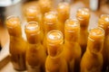 Little bottles filled with dense and vivid orange liquid