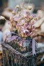 Little bouquet of dry immortelle wild flowers in violet, pink colors in small glass vases outdoors. Bunch of flowers Royalty Free Stock Photo