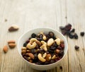 Little bowl with mixed nuts and dried fruits on the wooden table Royalty Free Stock Photo