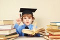 Little boy in academic hat quoted old book