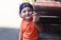 Little boy with an acorn in his hand near the table on the street Royalty Free Stock Photo