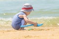 Little boy alone playing on the sea beach with sand Royalty Free Stock Photo