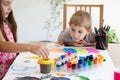 Little boy is amused by sister`s painting Royalty Free Stock Photo