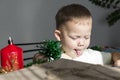 A little boy in anticipation of Christmas and new year, shows his tongue
