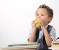 Little boy with apple and books stock photo