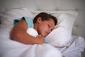 Bedtime is important for a growing boy. A little boy asleep in his bed.