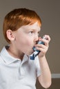 Little boy with asthma using his inhaler