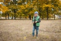 Little boy in autumn land scape