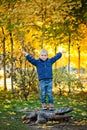 A little boy in an autumn Park. A happy child throws fallen leaves up while playing in an autumn Park. Children walk in the autumn Royalty Free Stock Photo