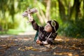 Little boy with aviator hat, lying on the ground in a park Royalty Free Stock Photo