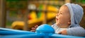 Little boy, baby. Children play and enjoy riding the carousel in the playground Royalty Free Stock Photo