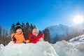 Little boy with baby girl stand in the snow fortress Royalty Free Stock Photo