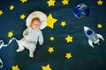 Little boy baby sleeping in a suit of the astronaut on the background of the starry sky Royalty Free Stock Photo