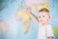 Little boy on the background of a world map Royalty Free Stock Photo