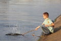 Little boy with backpack near pond Royalty Free Stock Photo