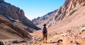 little boy with a backpack stands along the path against the backdrop of the mountains. travel with children to the mountains. Royalty Free Stock Photo