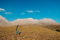 a little boy with a backpack walks along a path against the backdrop of mountains. travel with children to the mountains. Turkey. Royalty Free Stock Photo