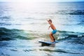 Little boy balancing on the surf board in sea Royalty Free Stock Photo