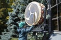 Little boy banging Japanese musical instrument taiko using drumsticks