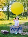 Little boy in a basket with balloon