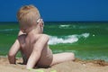 Little boy on the beach. child sitting in sand.Summer.sea.sky Royalty Free Stock Photo