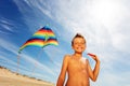 Little boy on the beach with colorful kite smile