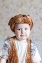 A little boy in a bear costume. A child in a carnival costume. Portrait of child.