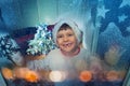 Little boy behind frozen window before Christmas Royalty Free Stock Photo