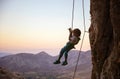 Little boy being lowered down while top rope climbing Royalty Free Stock Photo