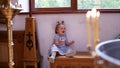 Little girl on bench in Orthodox Church, first visit to Church