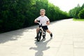 Little boy on a bicycle. Caught in motion, on a driveway. Presch