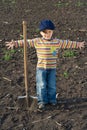 Little boy with big shovel in the field Royalty Free Stock Photo