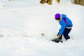 Little boy with big shovel removes snow after a snowstorm Royalty Free Stock Photo
