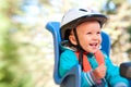 Little boy in bike child seat happy