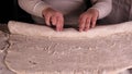 A little boy on a black background helps his father dad chef, preparing the dough to roll out for the pizza buns bread cakes and Royalty Free Stock Photo